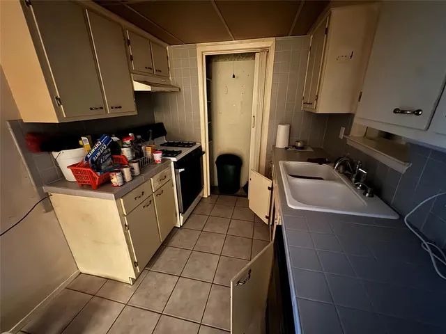 a kitchen with a refrigerator and cabinets