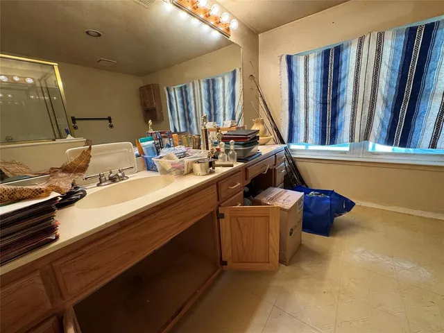 a bathroom with a double vanity sink and a mirror