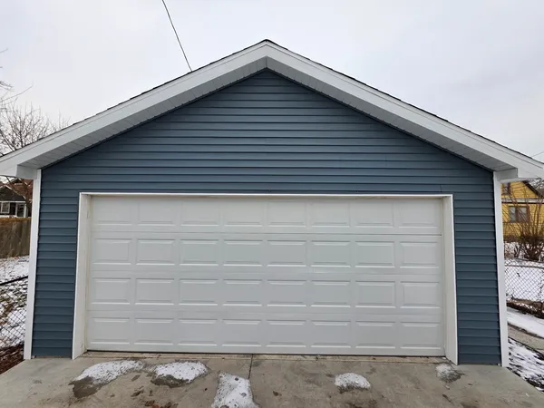 a small white building with a large window