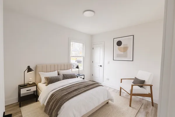 a bedroom with a bed and a lamp with window
