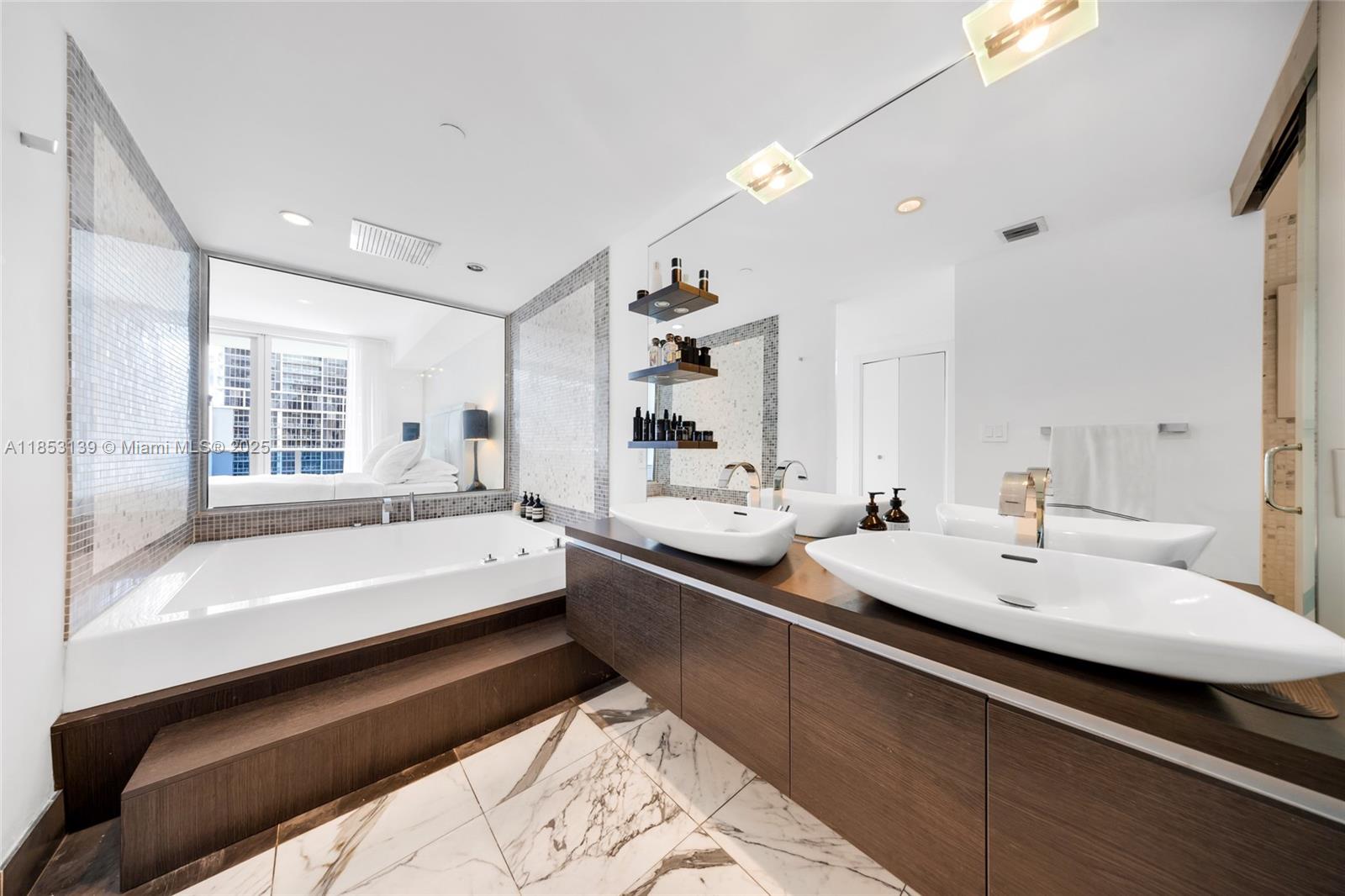 200 Biscayne Blvd Way, Unit 904 Miami, FL 33131 - Photo 15 of 24 a bathroom with a bathtub and a sink