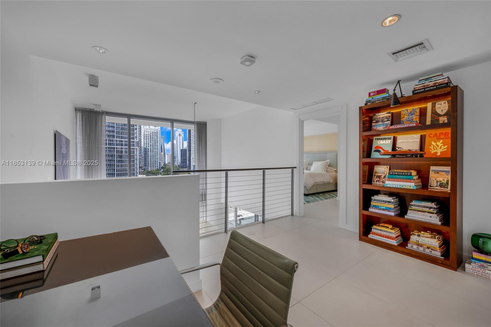 200 Biscayne Blvd Way, Unit 904 Miami, FL 33131 - Photo 18 of 24 a bedroom with furniture and a book shelf