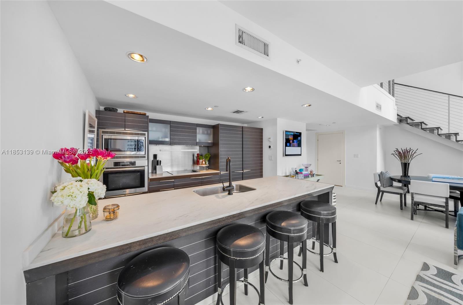 200 Biscayne Blvd Way, Unit 904 Miami, FL 33131 - Photo 9 of 24 a kitchen with a dining table and chairs