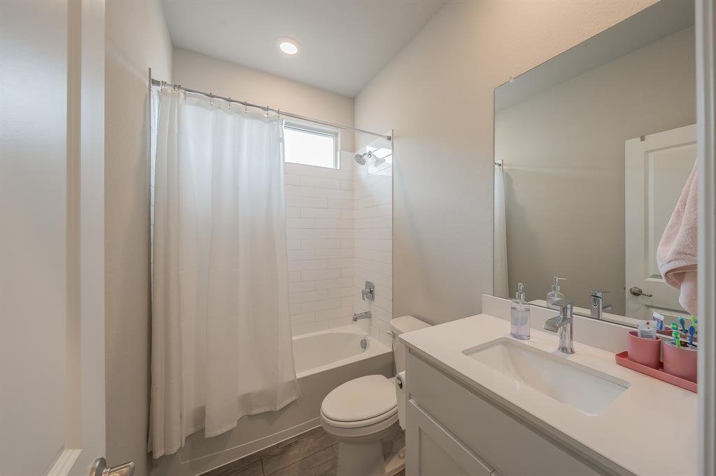 1212 Bosque Lane Weatherford, TX 76087 - Photo 16 of 38 a bathroom with a granite countertop sink a toilet a mirror and shower