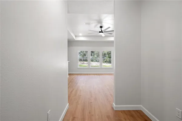 a view of an empty room with a fireplace and a window
