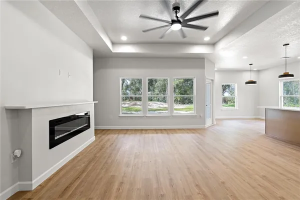 a living room with a fireplace and wooden floor