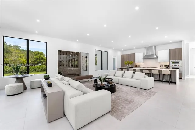 a living room with furniture flat screen tv and a large window