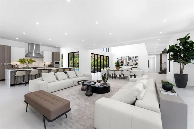 a kitchen with stainless steel appliances a sink a table and chairs