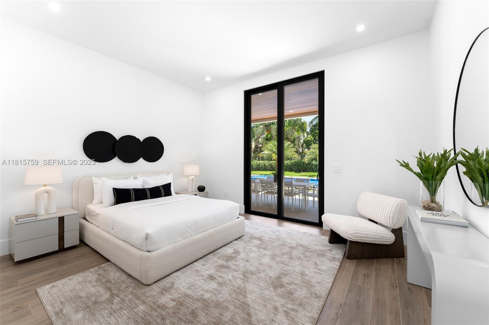6200 Moss Ranch Road Pinecrest, FL 33156 - Photo 20 of 58 a bedroom with a bed and a large window