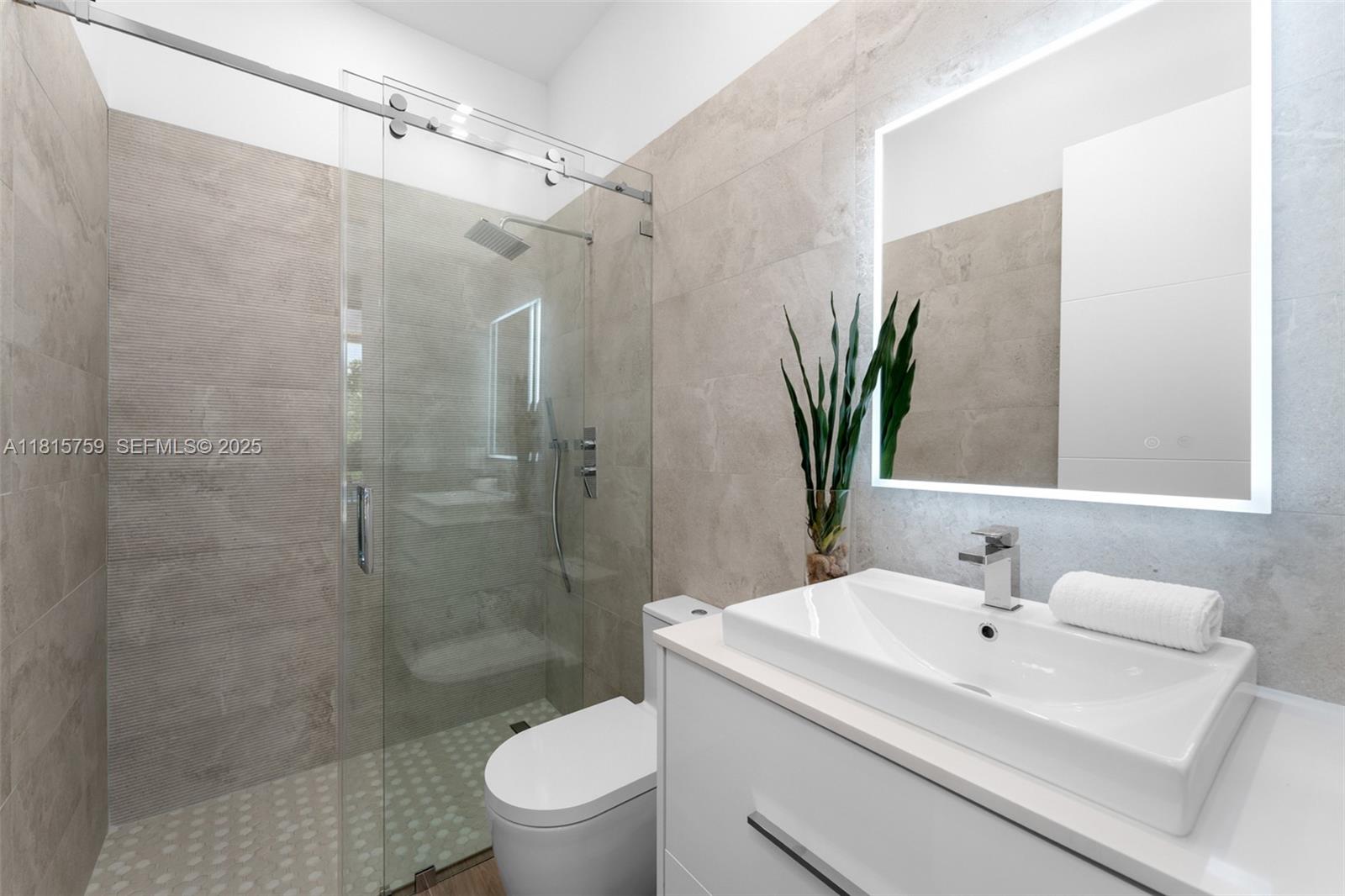 6200 Moss Ranch Road Pinecrest, FL 33156 - Photo 21 of 58 a bathroom with a sink a toilet and shower