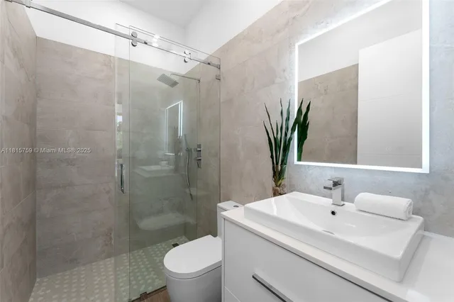 a bathroom with a sink toilet and shower