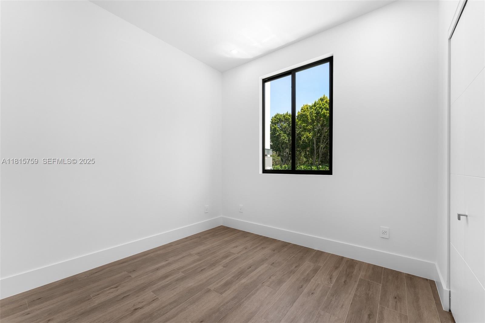 6200 Moss Ranch Road Pinecrest, FL 33156 - Photo 24 of 58 a view of an empty room with wooden floor and a window