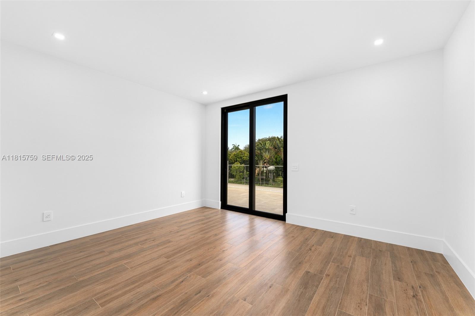 6200 Moss Ranch Road Pinecrest, FL 33156 - Photo 33 of 58 a view of an empty room with wooden floor and a window
