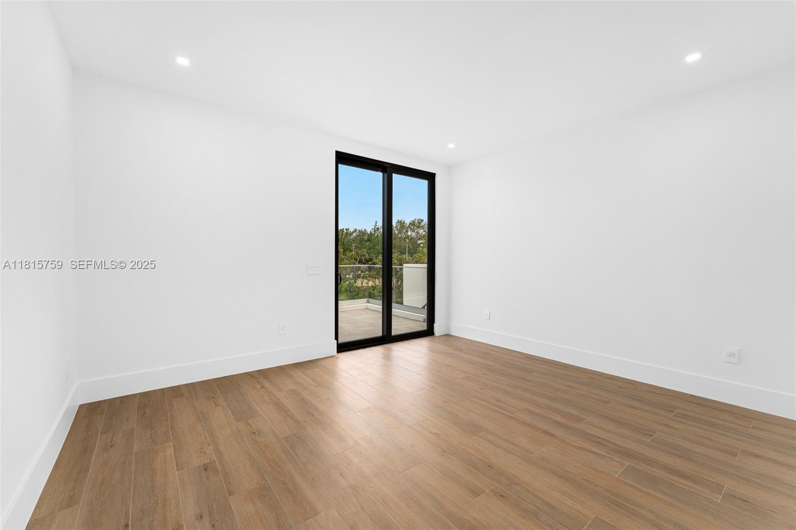 6200 Moss Ranch Road Pinecrest, FL 33156 - Photo 35 of 58 a view of an empty room with wooden floor and a window