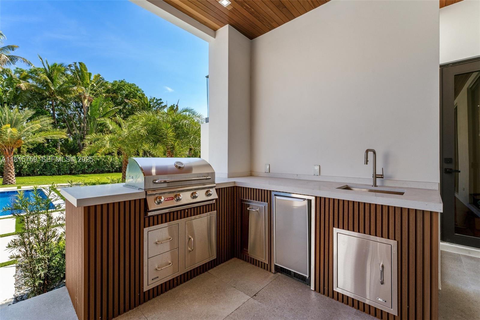 6200 Moss Ranch Road Pinecrest, FL 33156 - Photo 39 of 58 a kitchen with a stove top oven and sink