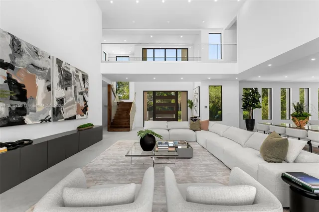 a living room with furniture and large windows