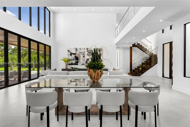 a living room with furniture and view of kitchen