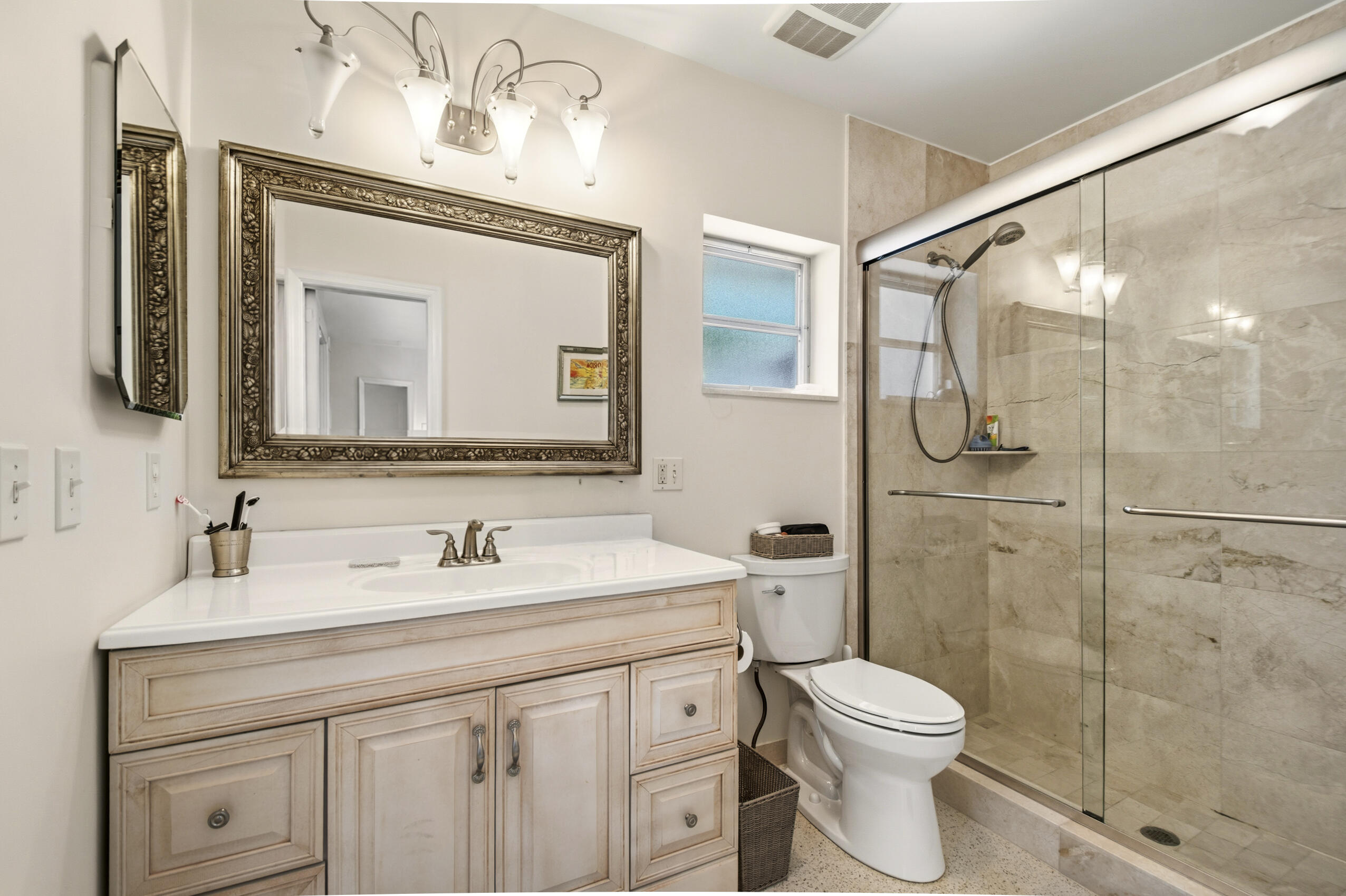 1348 Southwest 4th Street Boca Raton, FL 33486 - Photo 17 of 44 a bathroom with a toilet sink and shower