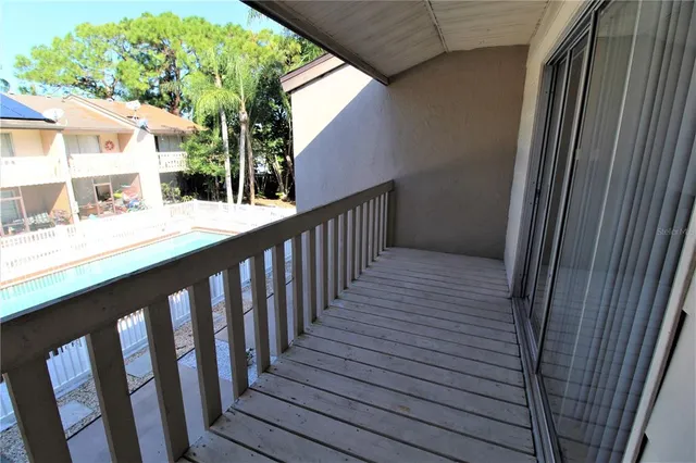 a view of balcony with wooden floor