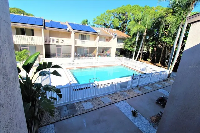 a view of a house with backyard and sitting area