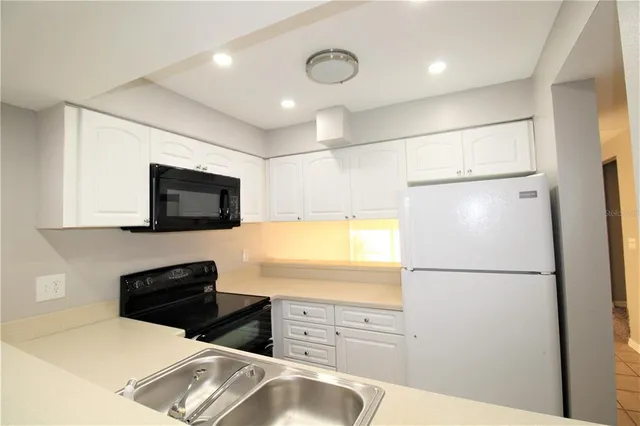 a kitchen with stainless steel appliances a refrigerator stove and microwave