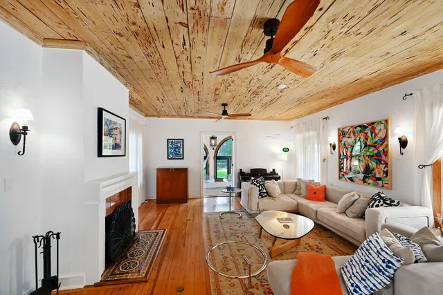a living room with furniture and wooden floor