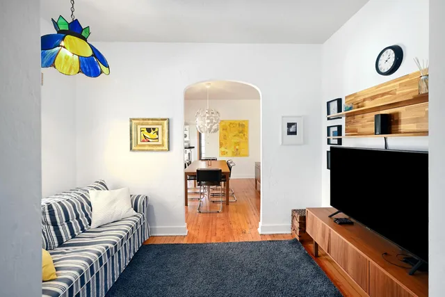 a living room with furniture and flat screen tv