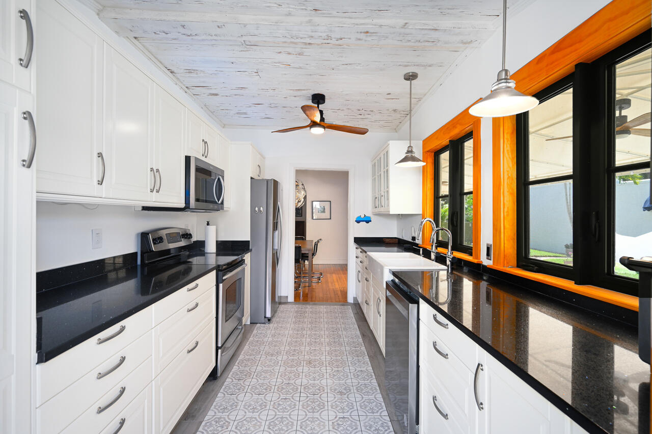 801 Hibiscus Street Boca Raton, FL 33486 - Photo 19 of 60 a large kitchen with stainless steel appliances granite countertop a stove and cabinets