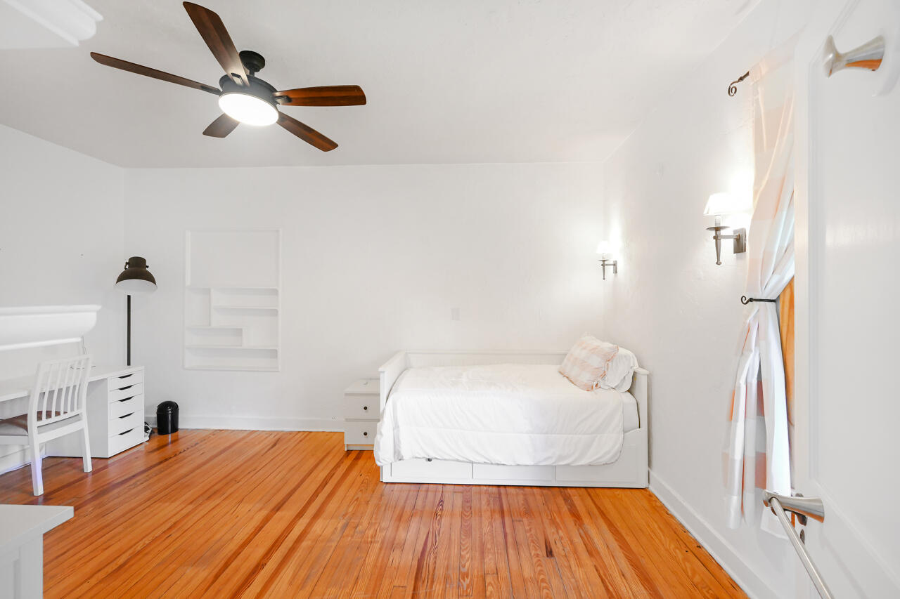 801 Hibiscus Street Boca Raton, FL 33486 - Photo 21 of 60 a bedroom with a bed and wooden floor