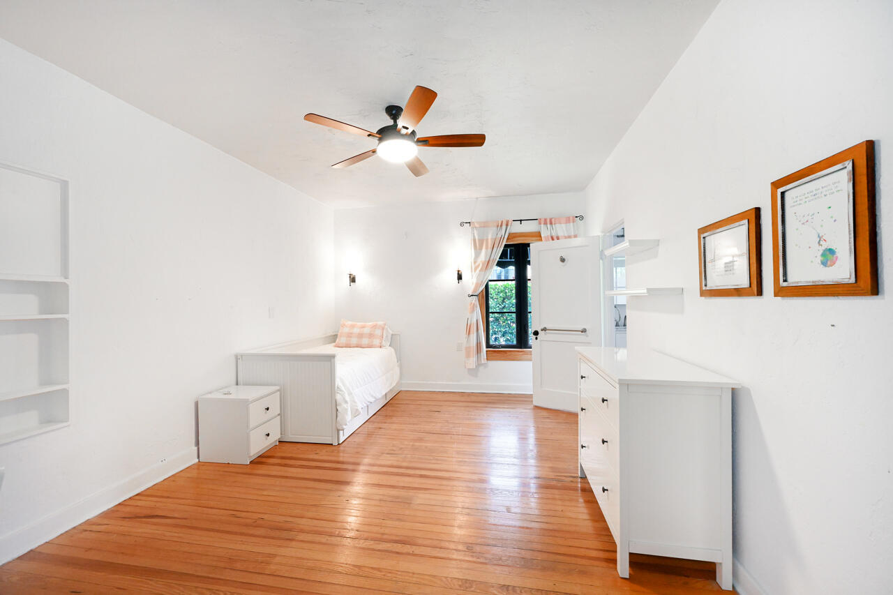 801 Hibiscus Street Boca Raton, FL 33486 - Photo 22 of 60 a bedroom with a bed and a chandelier