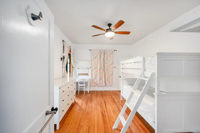 a bed sitting in a bedroom and a chandelier