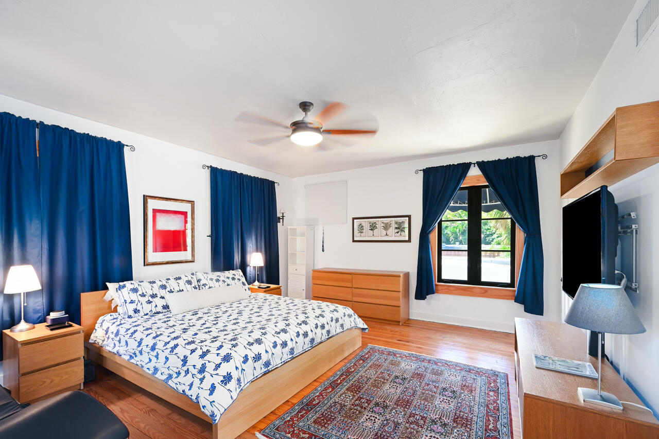 801 Hibiscus Street Boca Raton, FL 33486 - Photo 29 of 60 a bedroom with a large bed and a chandelier