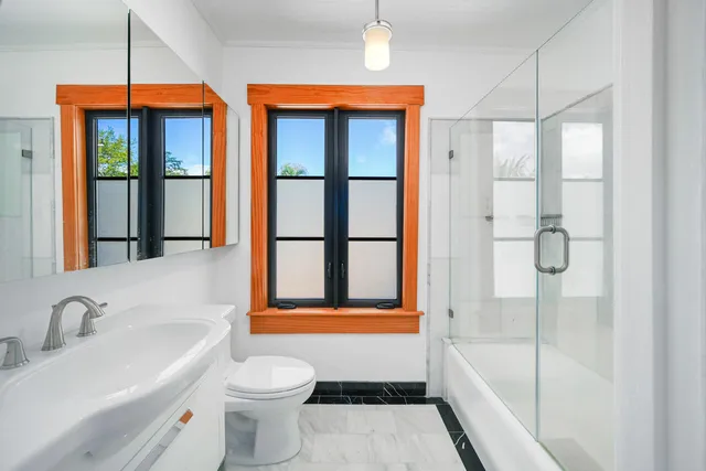 a front view of a house with swimming pool having outdoor seating