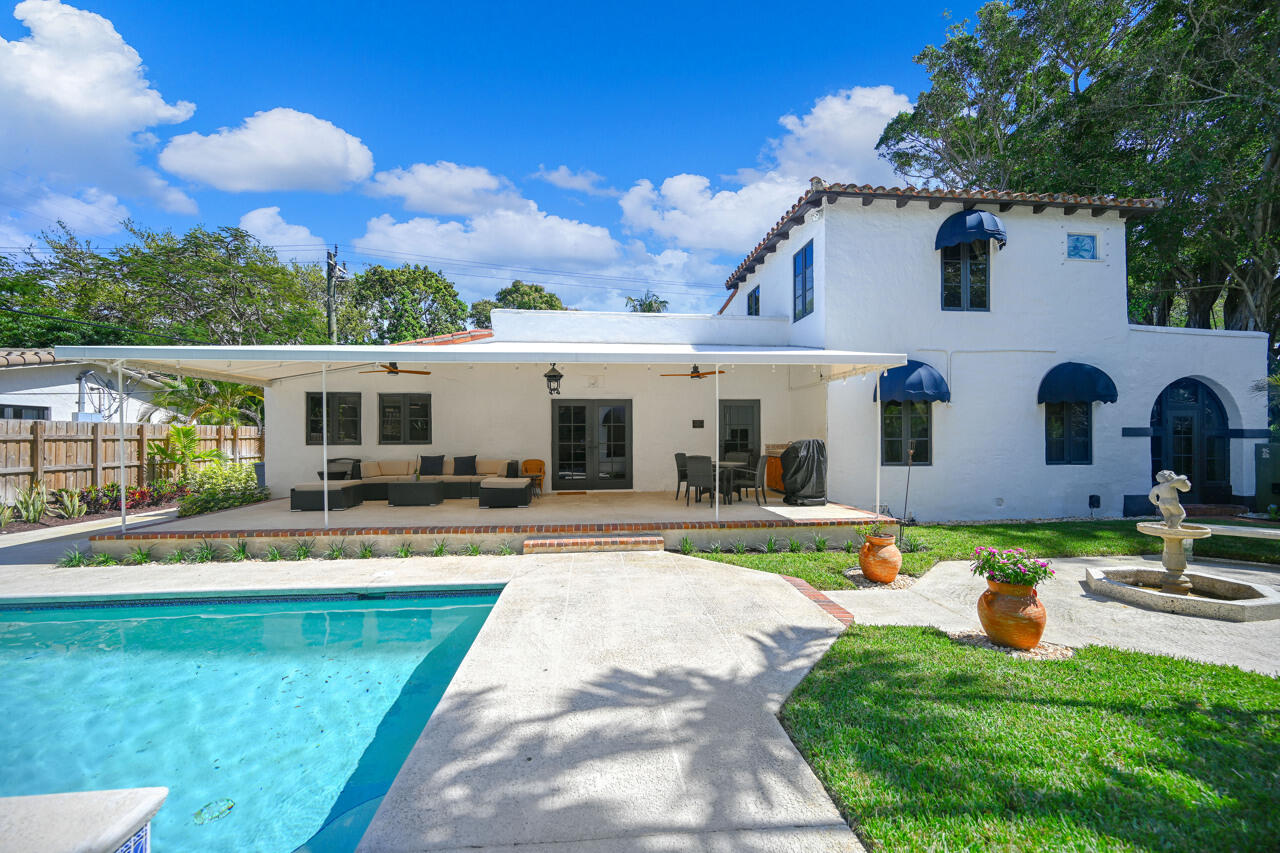 801 Hibiscus Street Boca Raton, FL 33486 - Photo 36 of 60 a view of a house with swimming pool and a yard