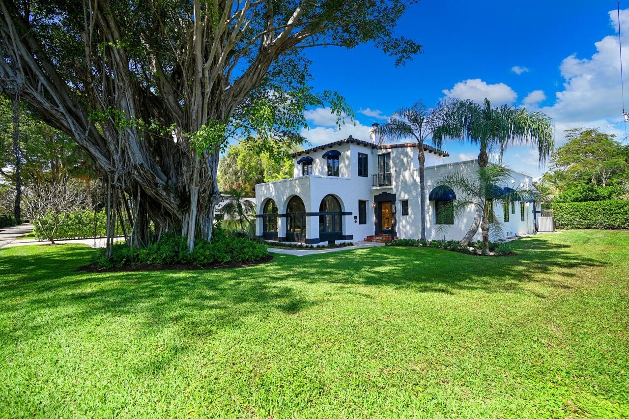 801 Hibiscus Street Boca Raton, FL 33486 - Photo 59 of 60 a view of a white house with a big yard and large trees