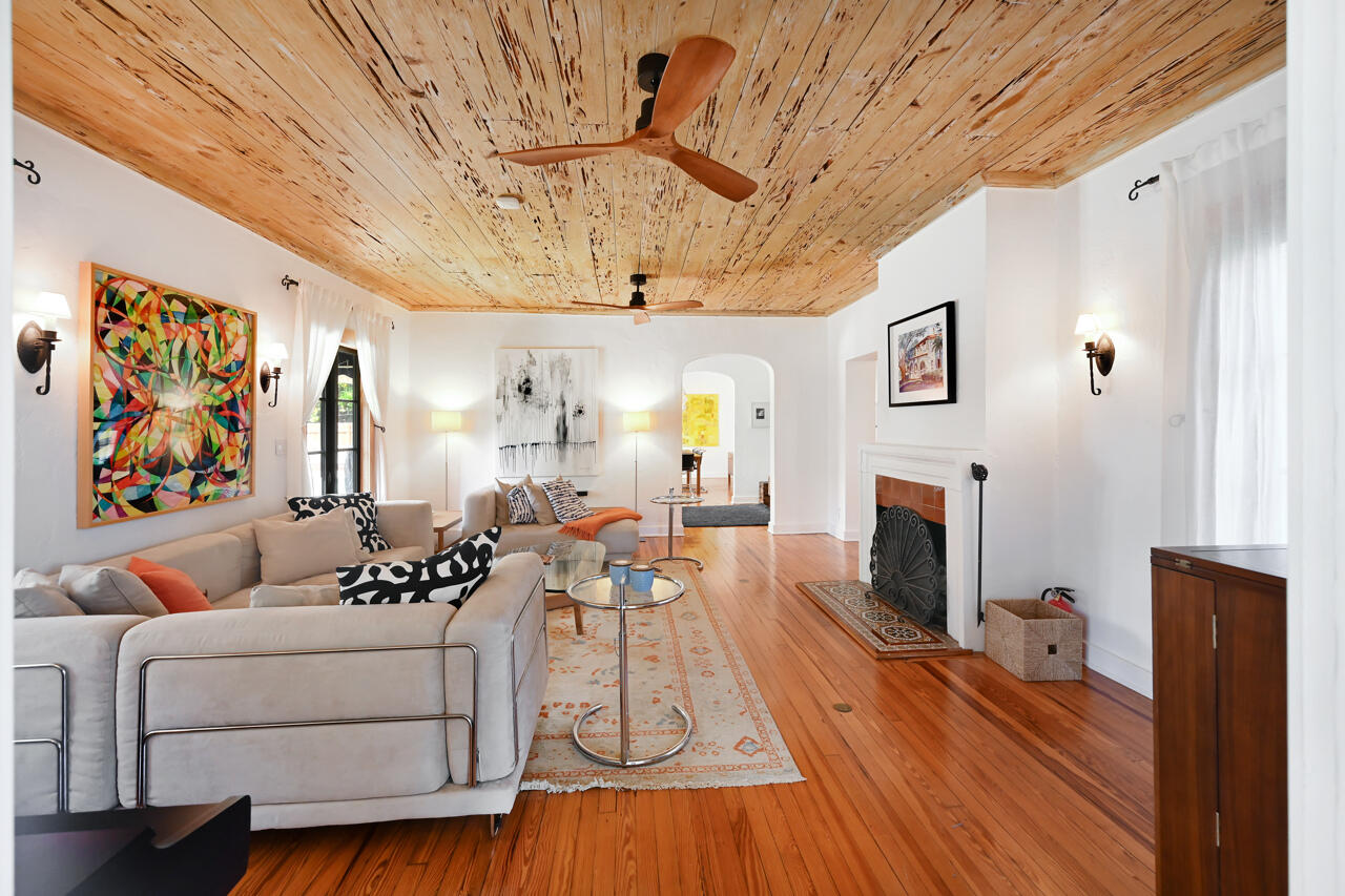 801 Hibiscus Street Boca Raton, FL 33486 - Photo 9 of 60 a living room with furniture a fireplace and a flat screen tv