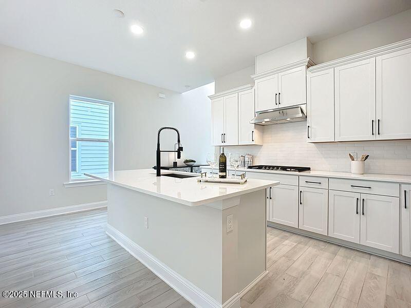 92 Bedford Terrace, Unit 60 St. Augustine, FL 32092 - Photo 15 of 42 a kitchen with sink stove and cabinets