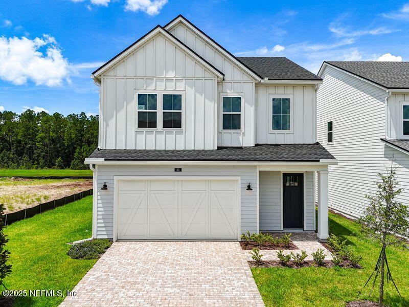 92 Bedford Terrace, Unit 60 St. Augustine, FL 32092 - Photo 2 of 42 a front view of a house with garden