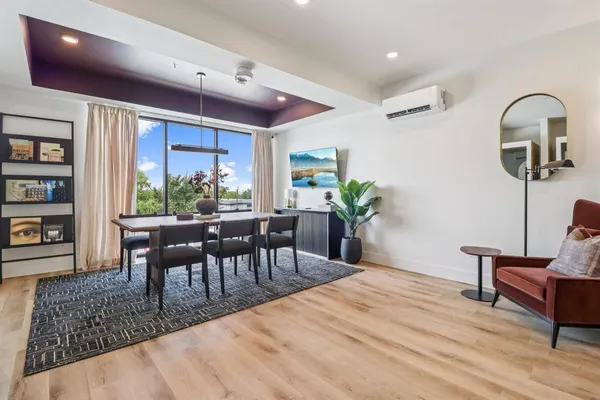 a dining room with furniture and window
