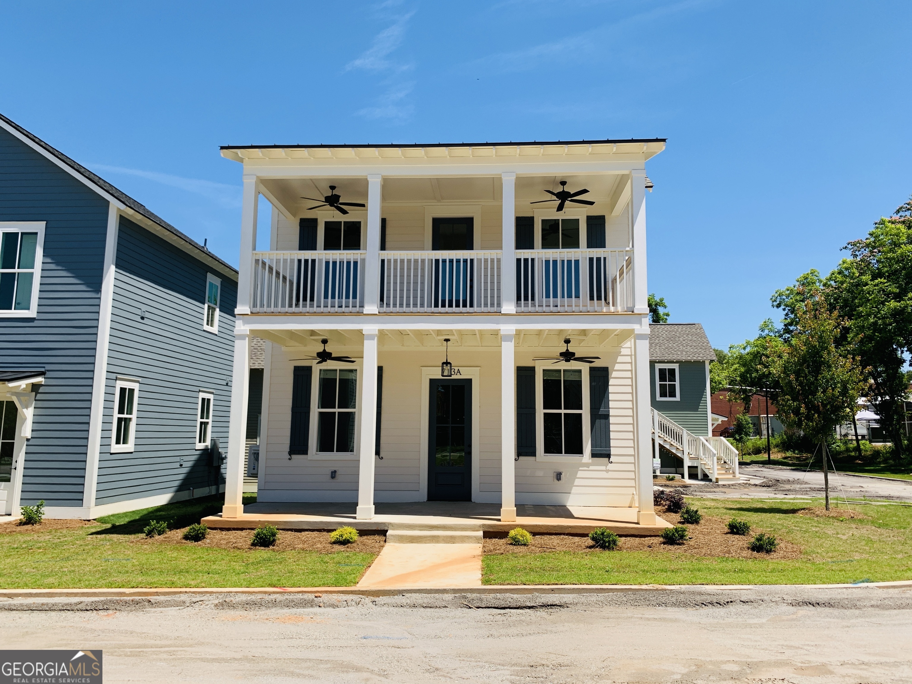 a front view of a house with swimming pool and yard