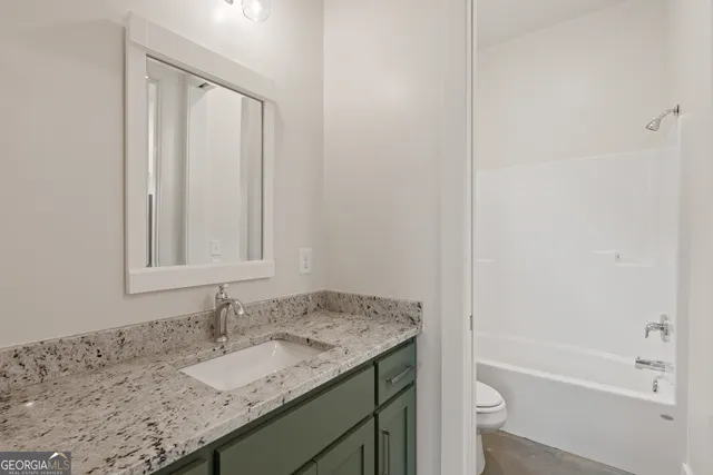 a aerial view of a house with a yard table and chairs