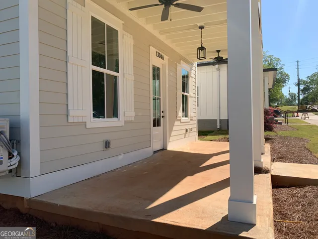 a view of a porch with a table and chairs