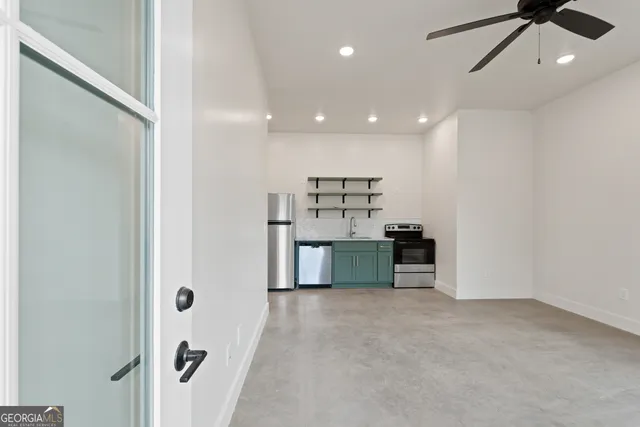 a view of a kitchen with a sink and a refrigerator