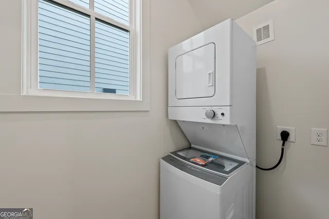 an empty room with a empty space and windows