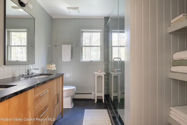 a bathroom with a granite countertop sink toilet and shower