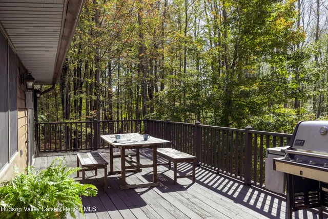 a patio with glass top table and chairs