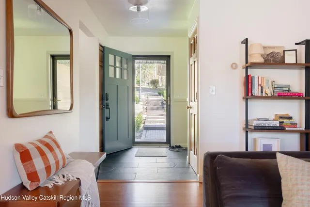 a living room with furniture and a walk in closet