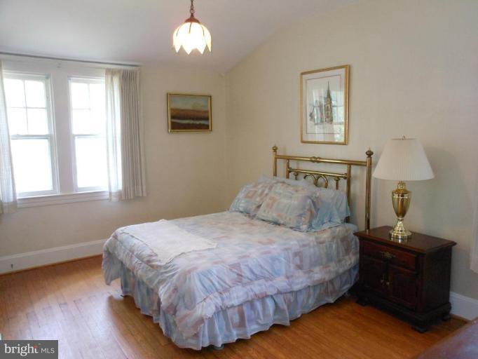 616 North Bend Road Baltimore, MD 21229 - Photo 8 of 18 a bedroom with a bed and wooden floor