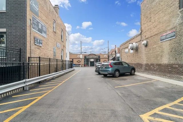 a view of a city street with tall buildings