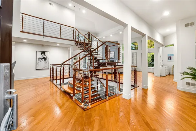 a view of entryway and hall with wooden floor